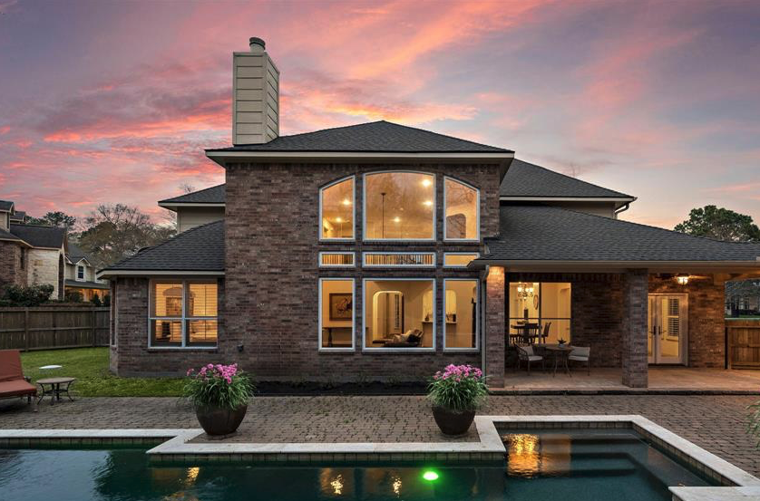 Champion Forest Exteriors team member meeting with a homeowner showcasing decades of remodeling experience and friendly local service.