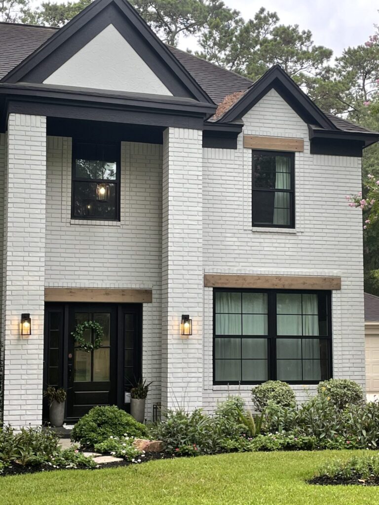Champion Forest Exteriors family ownership team and local crew in front of a completed Houston area home exterior project underscoring community rooted service.