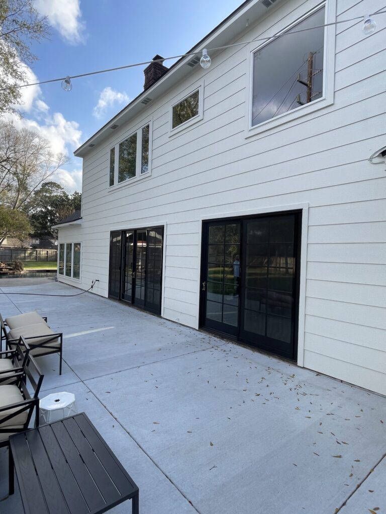 Champion Forest Exteriors installing HardiePlank siding on a Gulf Coast home designed to withstand humidity heat and severe weather.