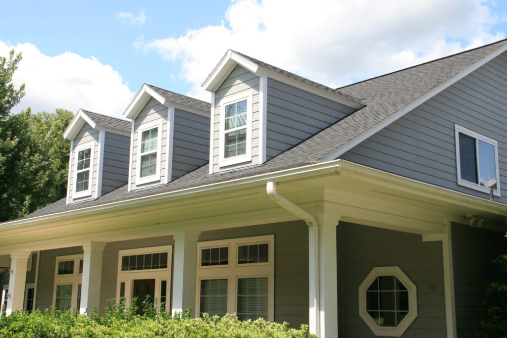 Champion Forest Exteriors installing HardiePlank siding on a Houston home offering durable protection and long lasting curb appeal.