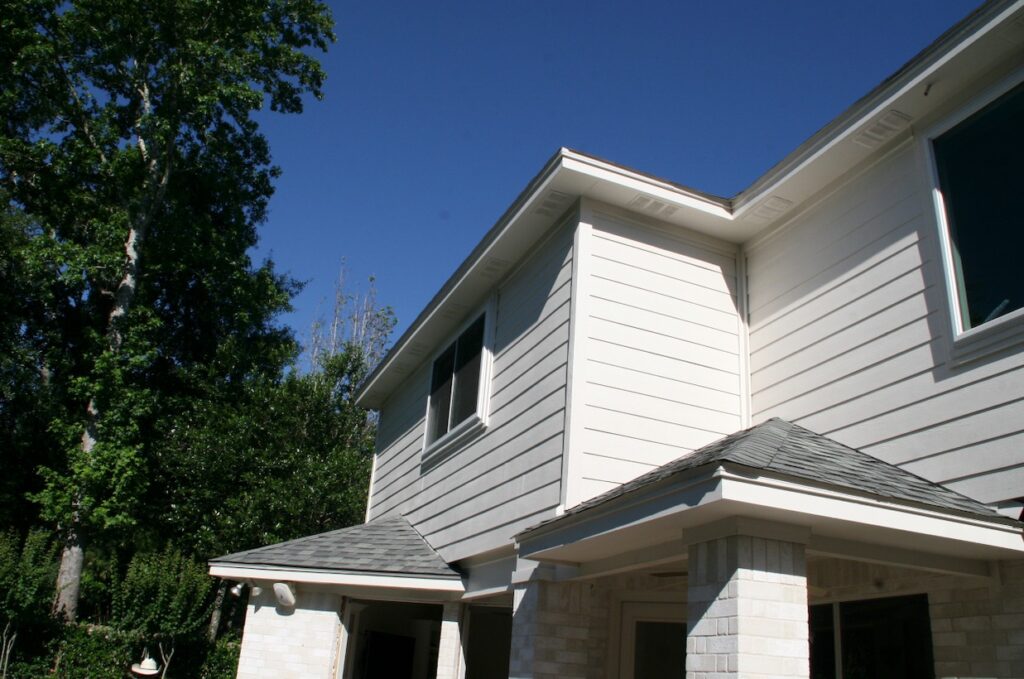 Champion Forest Exteriors team installing siding on a home with attention to detail and expert craftsmanship.