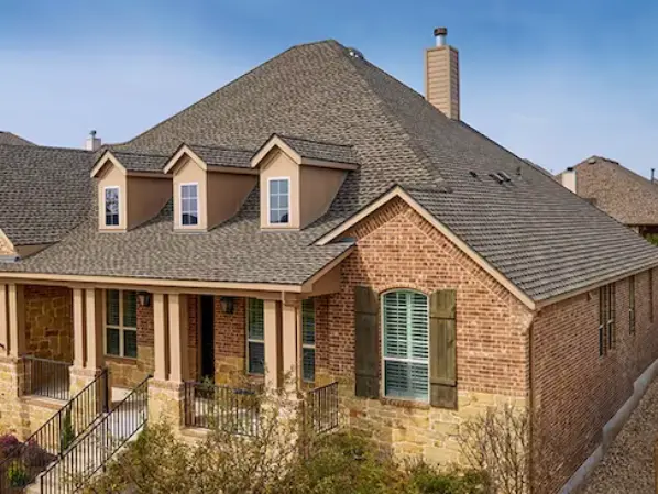 Champion Forest Exteriors installing a full GAF roofing system including underlayment shingles flashing and ridge ventilation for total roof protection.