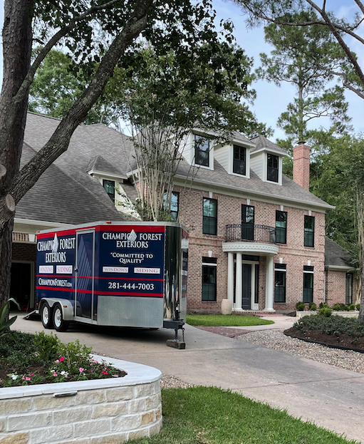 Champion Forest Exteriors team smiling and ready to begin a new exterior remodeling project with a homeowner.
