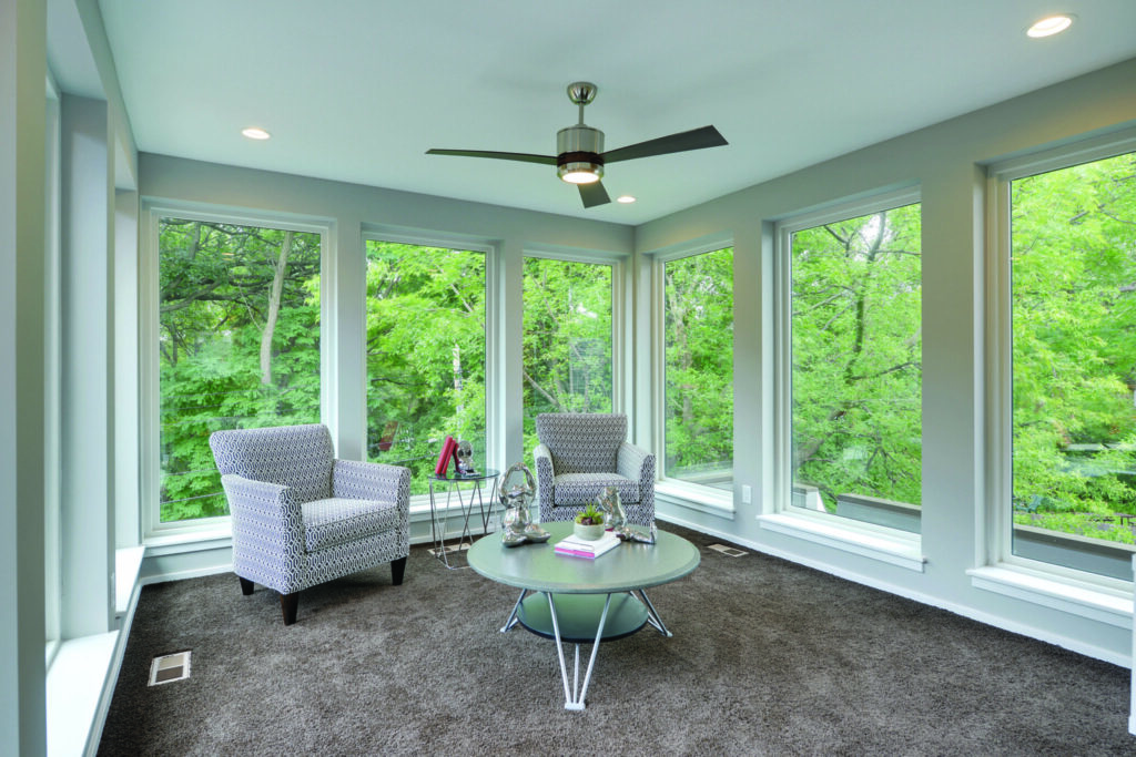 Champion Forest Exteriors expert showing a homeowner window replacement options including styles energy ratings and frame materials.